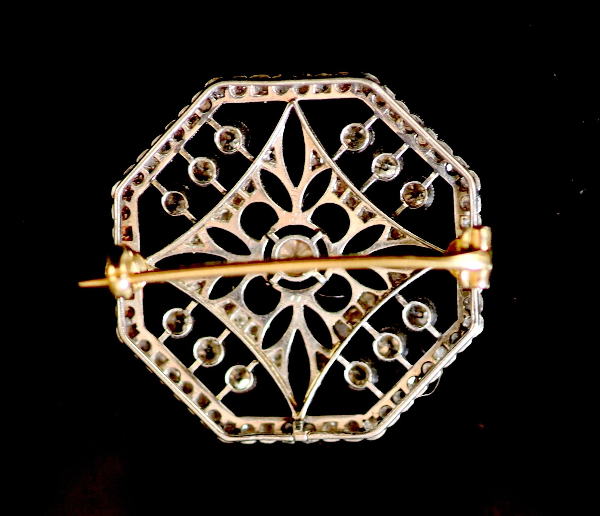 A Belle Epoque platinum, round and rose cut diamond millegrain set octagonal open work brooch